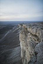 Ukraine, Crimea, Hiker on edge of steep cliff near White Mountain
