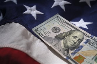 US one hundred dollar bill on national flag