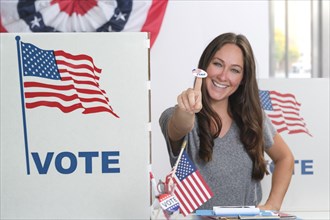 Woman holding voting sticker