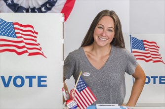Smiling woman standing in polling place