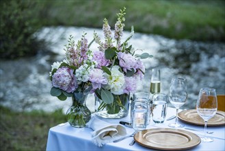 Outdoor dinner table setting with fresh flowers,,