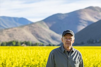 USA, Farmer standing in mustard field,