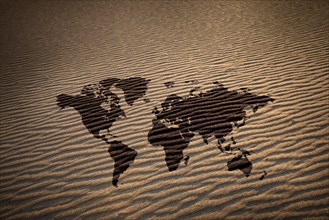 World map against desert sand,,