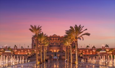 United Arab Emirates, Abu Dhabi, Palm trees and fountain in front of Hotel Emirates Palace