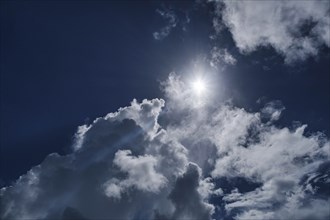 White clouds and sun on blue sky