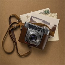 Retro amateur 35mm camera with postcards and letters