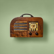 Retro wooden radio on green background