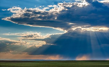 USA, South Dakota, Storm clouds at sunset over prairie