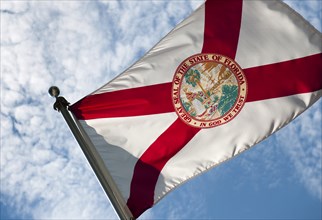 USA, Florida, State flag of Florida against cloudy sky