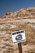 USA, South Dakota, Badlands National Park, Beware of Rattlesnakes sign in Badlands National Park