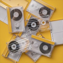 Analog audio cassettes on yellow background