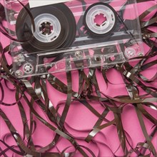Analog audio cassette on pink background