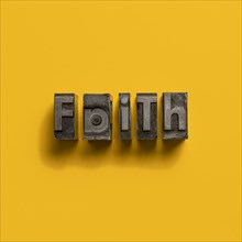 Wooden printer font letters spelling word Faith
