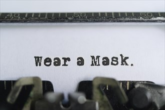 Typewriter text reading wear a mask