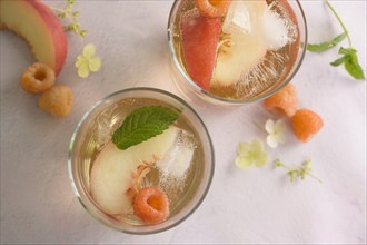 Peach cocktail with fresh raspberries
