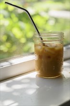 Iced coffee on windowsill