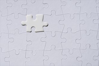 White jigsaw piece on jigsaw pattern