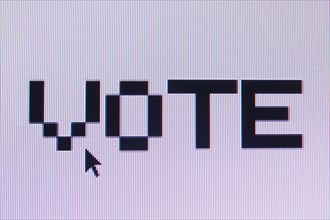 Computer monitor displaying the word vote