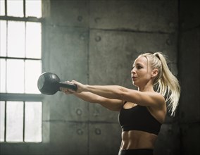 Woman exercising in warehouse