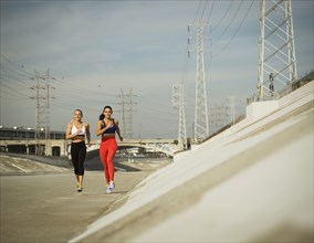 USA, California, Los Angeles, Two sporty women jogging in urban setting