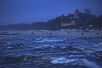 Poland, Pomerania, Leba, Castle at Baltic Sea coast at dusk