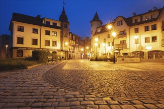 Poland, Pomerania, Lebork, Illuminated town square at night