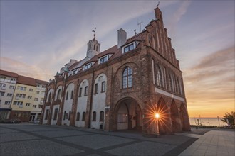 Poland, West Pomerania, Kamien Pomorski, Historic town hall at dusk