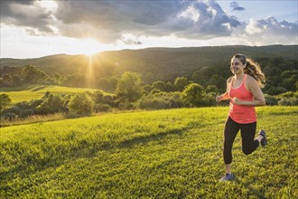 USA, Woman running in field