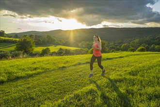 USA, Woman running in field