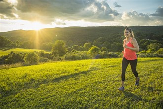 USA, Woman running in field