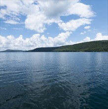 USA, New York, Cooperstown, Otsego Lake, Clouds over lake surrounded by hills