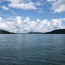 USA, New York, Cooperstown, Otsego Lake, Clouds over lake surrounded by hills