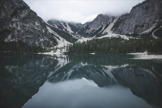 Italy, Pragser Wildsee, Dolomites, South Tyrol, Mountain range reflecting in lake