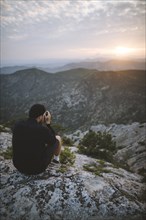 Italy, Liguria, La Spezia, Man at mountain top photographing mountain range