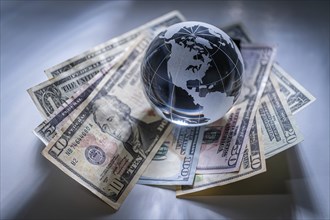 Glass globe and american dollar banknotes