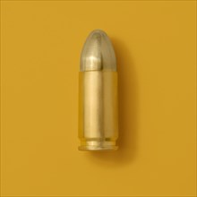 Gold bullet on yellow background