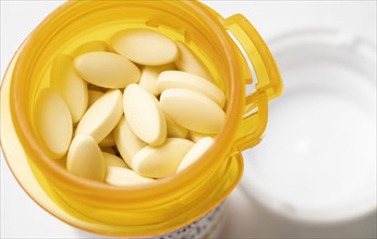 White pills in yellow container