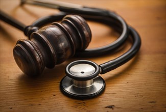 Gavel and stethoscope on wooden background