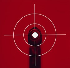 Shooting target on red background with gun