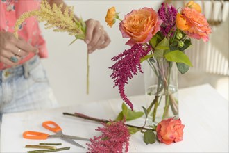 Woman making floral arrangement