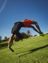 Man flipping over grass