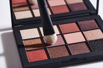 Close-up of palette of eyeshadows and brush
