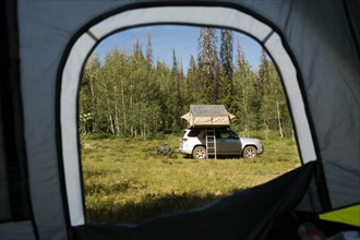 USA, Utah, Uinta National Park, View from tent on car parked in forest