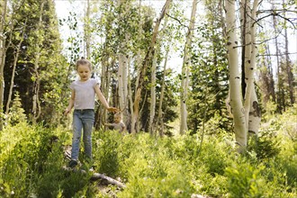 USA, Utah, Uinta National Park, Two sisters (2-3, 6-7) walking in forest