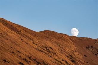 USA, Idaho, Sun Valley, Moon behind hill