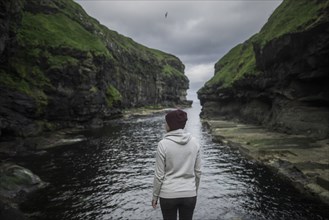 Denmark, Faroe Islands, Gjgv, Woman standing in gorge