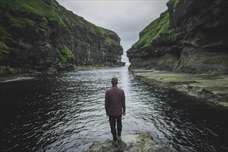 Denmark, Faroe Islands, Gjgv, Man standing in gorge
