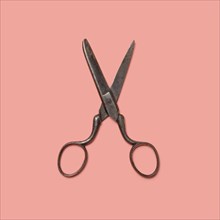 Studio shot of old fashioned scissors on pink background