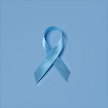 Studio shot of blue ribbon symbolizing prostate cancer