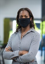 Portrait of businesswoman wearing face mask in office